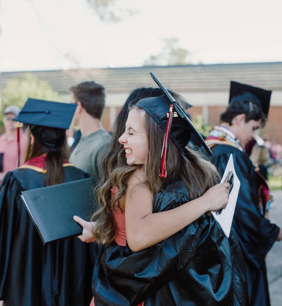 Graduates hugging