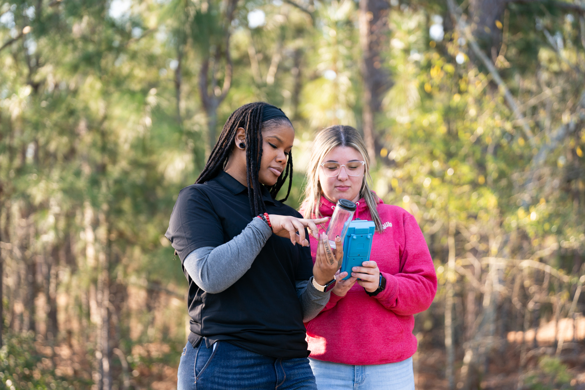 Two students with water sample