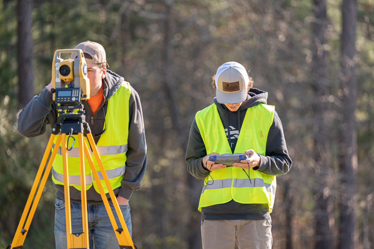 two students surveying