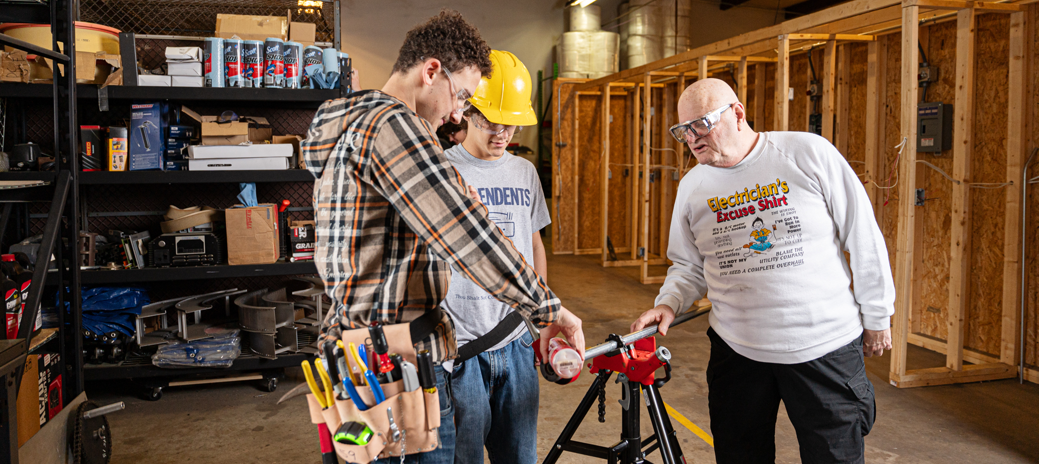 Two electrical students and their instructor