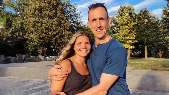 Portrait of Criss Cross Climbing Gym owners Christopher and Brittney Morton standing outdoors together.
