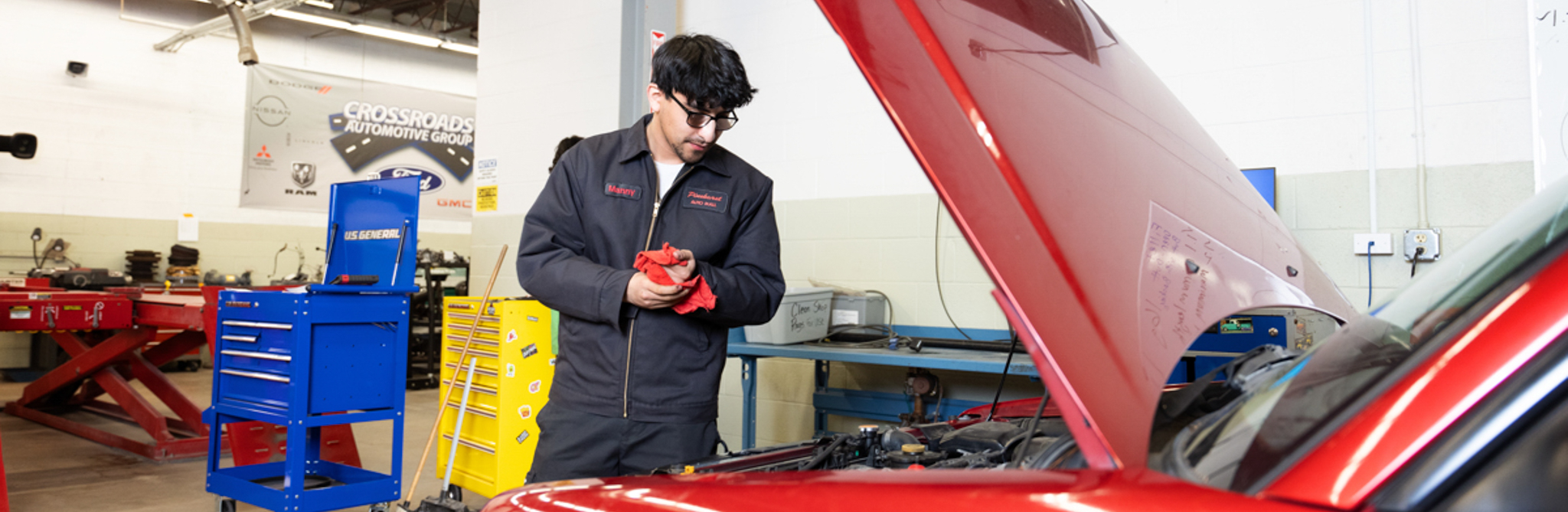 student working on car