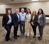 Sandhills Community College President Alexander “Sandy” Stewart stands with members of the Moldovan delegation visiting North Carolina.