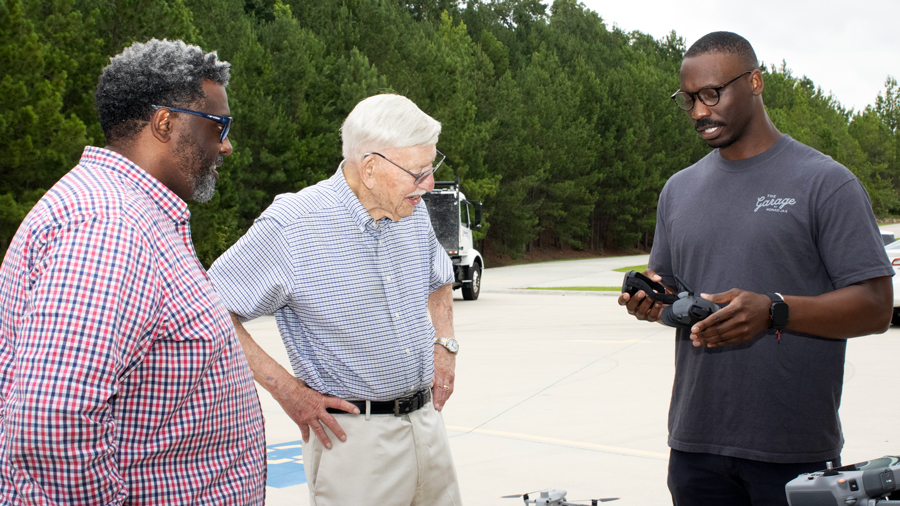 Tito Ward, Sandhills Community College Foundation, Edward Frick, and Donald Piper discuss drone technology during the launch of the Frick Drone Excellence Program at Sandhills Community College.