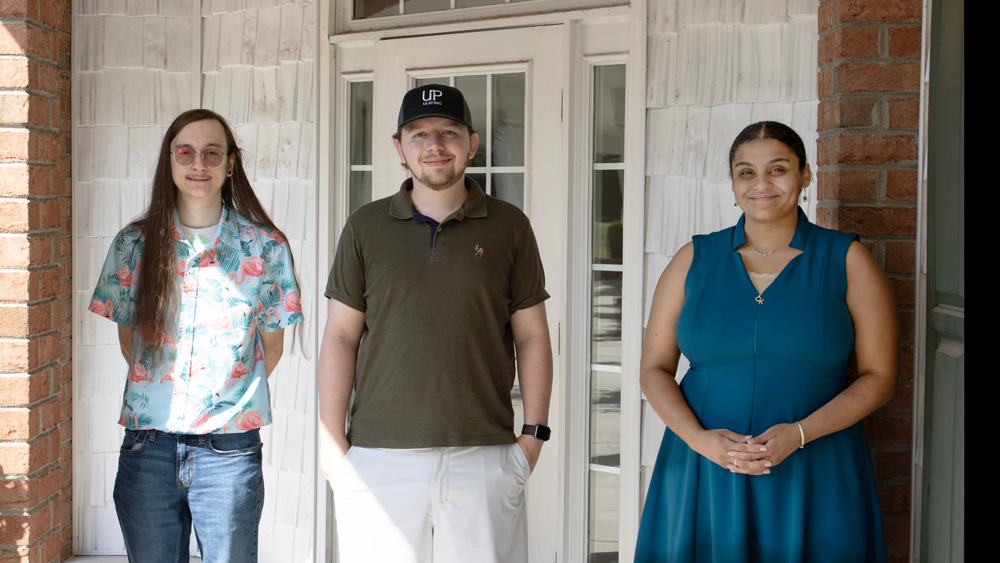 RhemaWeb apprentices Peyton Cuneo and Dana Spence stand with owner Nick Mihalovich outside the company.