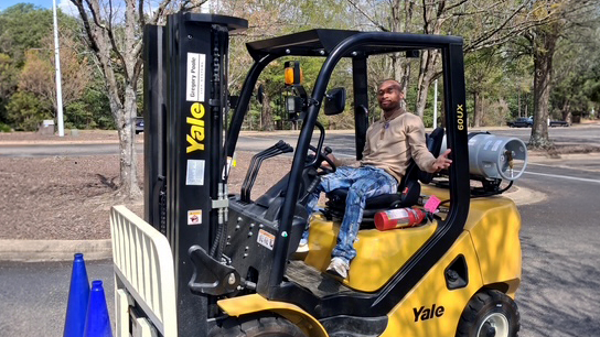 Joseph Littlejohn operates a forklift during his work at Sandhills Community College.