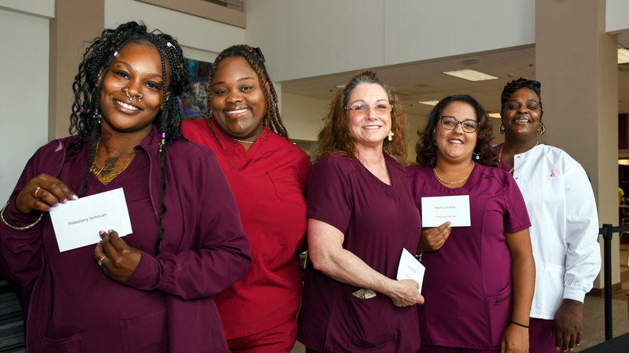 Graduates from healthcare training programs pose for a photo during the Sandhills Community College Workforce Continuing Education graduation ceremony.
