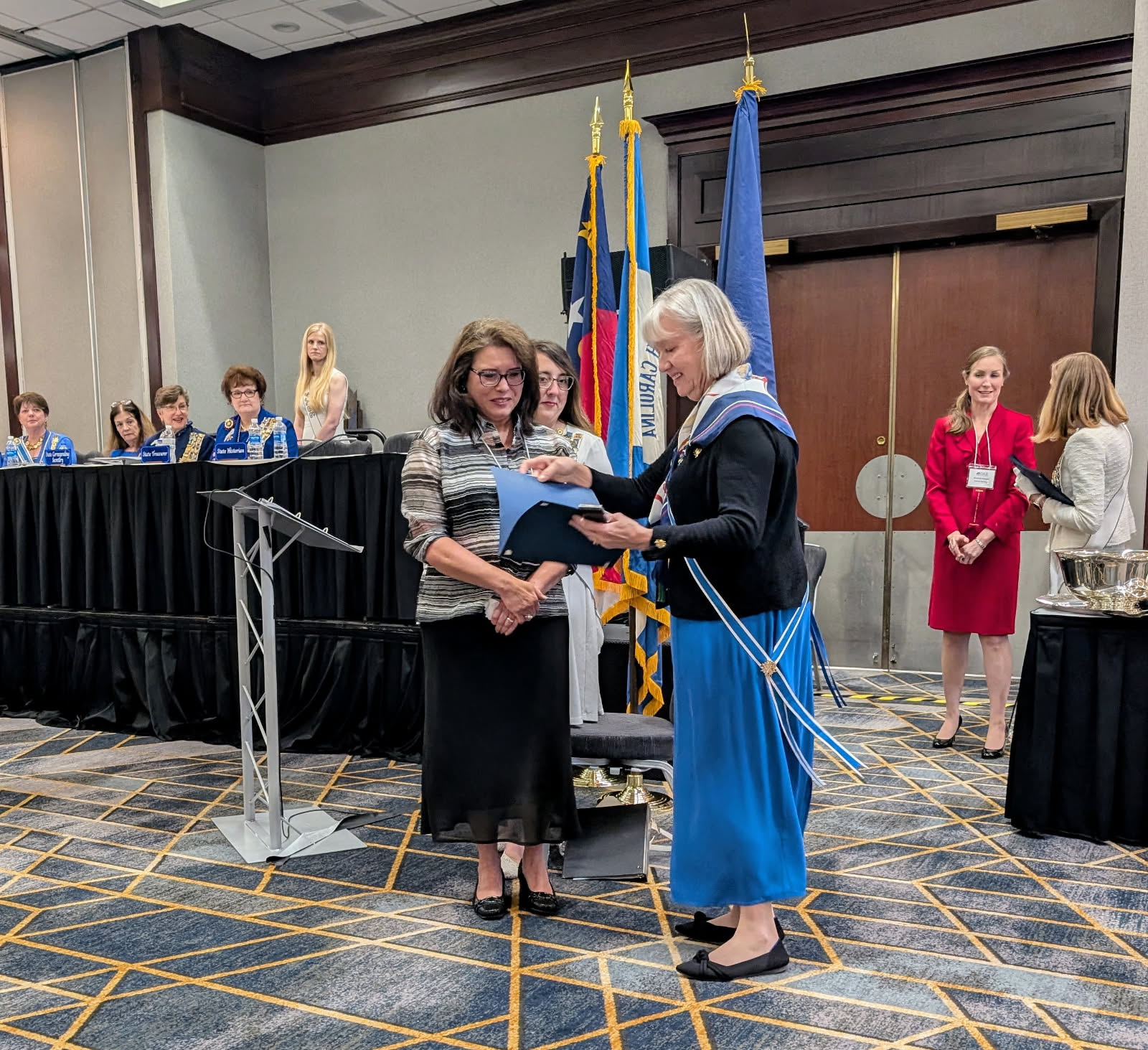 Maria Motta (left) receives national award from State Regent, Cricket Crigler at the 125th North Carolina DAR State Conference.
