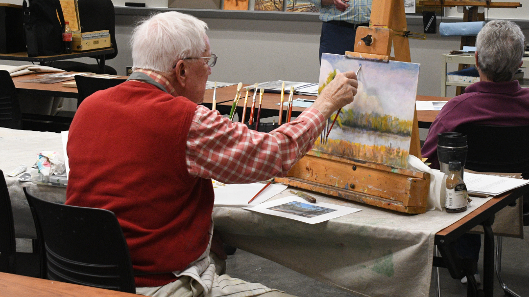 Pictured is a student in a painting class. 
