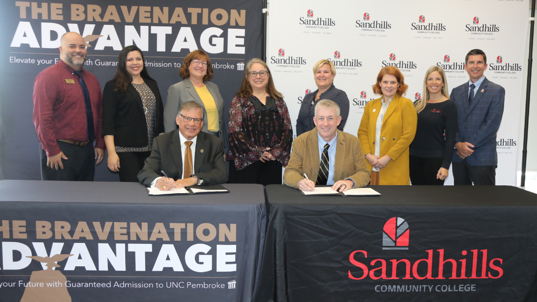 From UNCP, standing left to right: Chris Hunt Assistant Director of Undergraduate Admissions, Jamee Hunt Freeman, Director of Undergraduate Admissions, Dr. Kelly Brennan, Vice Chancellor for Enrollment Management and from Sandhills Community College, Dr. Rebecca Roush, Provost, Michelle Bauer, Vice Provost of Instructual Programs, Dr. Julie Voigt, Chief of Staff, Cary Green, Purpose Center Director, and Chad Williams, Vice President for Student Services.